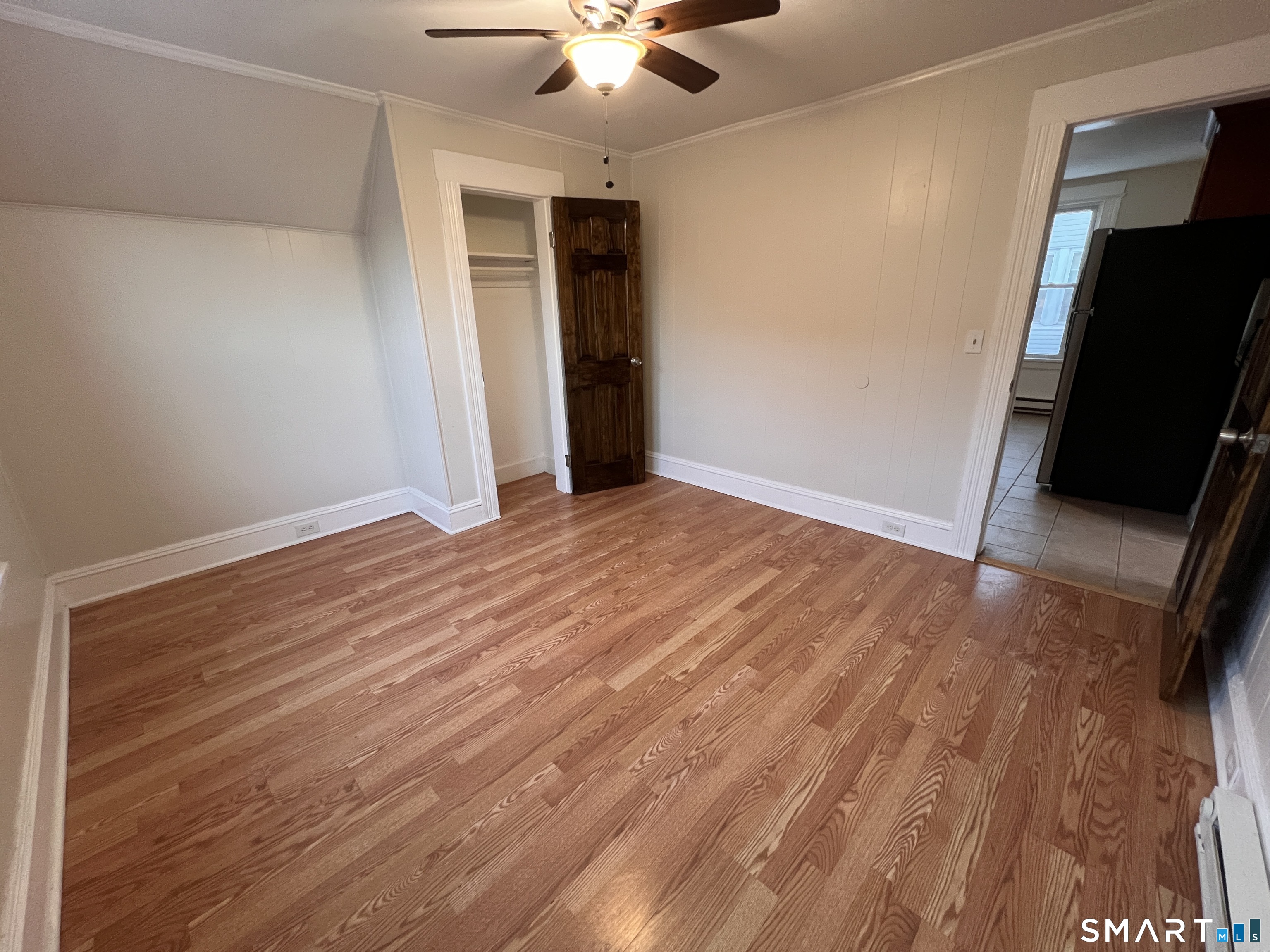 128 Prince Street Bridgeport, CT 06610 - Photo 8 of 19 an empty room with wooden floor and windows