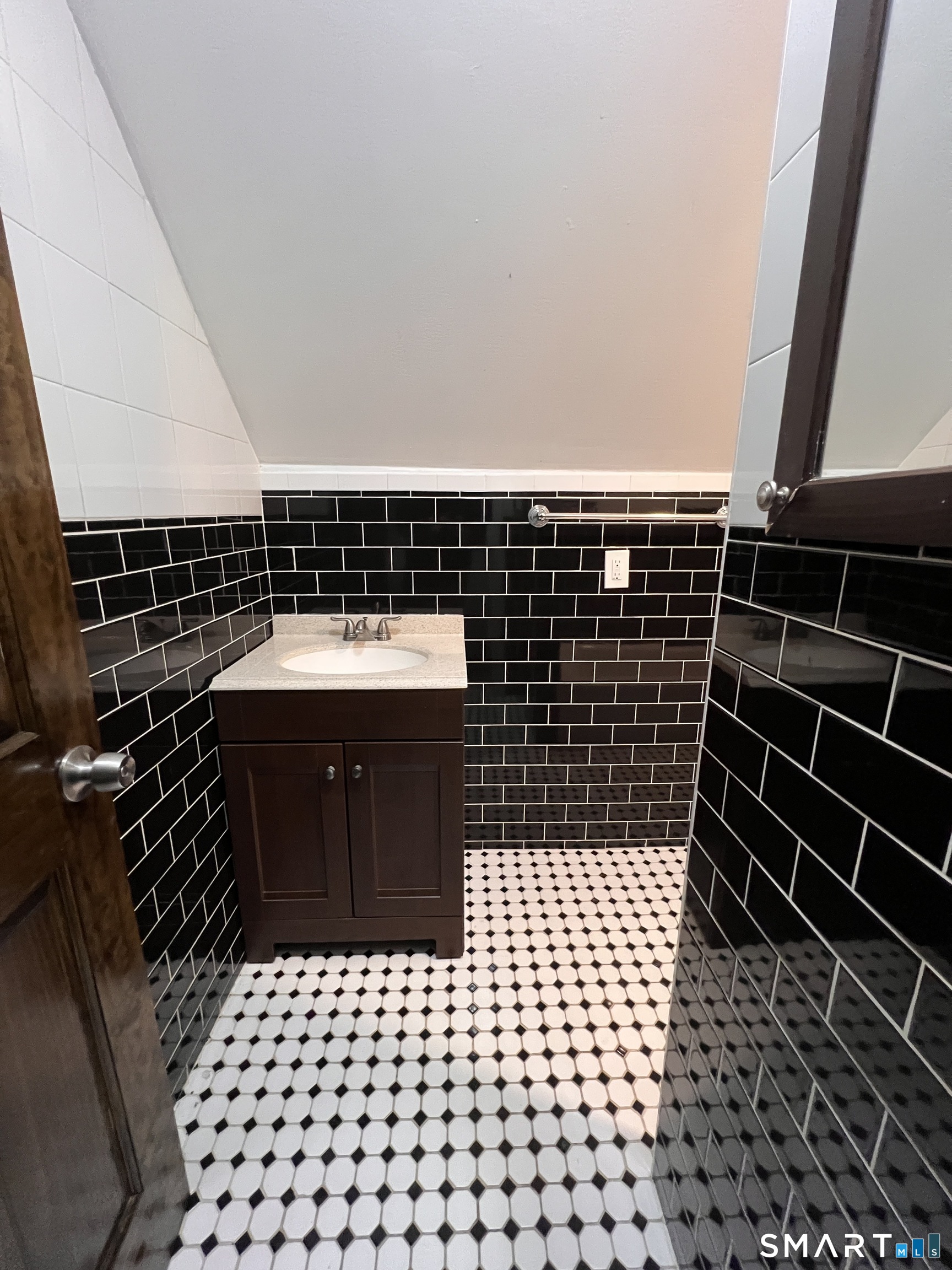 128 Prince Street Bridgeport, CT 06610 - Photo 9 of 19 a bathroom with a sink a toilet and a mirror