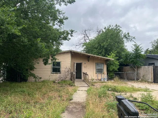 a house with trees in the background
