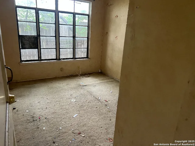 a view of an empty room with a window