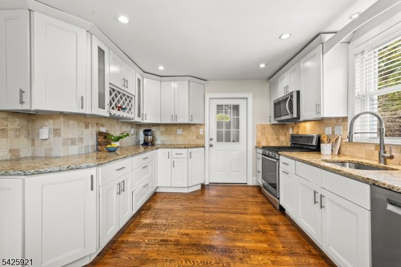 166 Valley Road Montclair, NJ 07042 - Photo 20 of 37 a kitchen with granite countertop a sink and cabinets