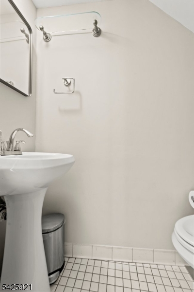 166 Valley Road Montclair, NJ 07042 - Photo 23 of 37 a bathroom with a sink a toilet and a mirror