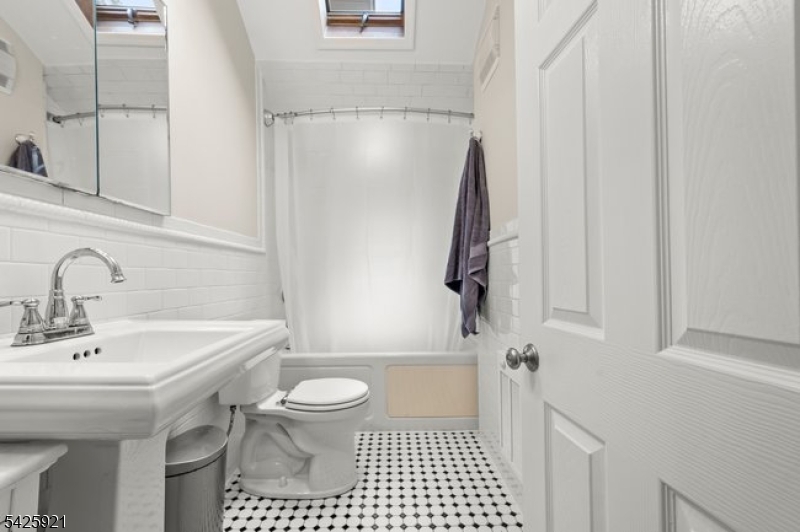 166 Valley Road Montclair, NJ 07042 - Photo 29 of 37 a bathroom with a sink toilet and shower