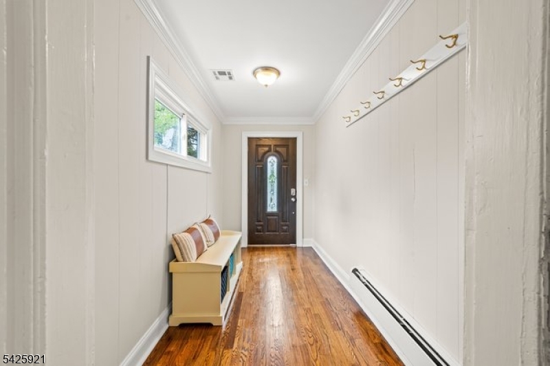 166 Valley Road Montclair, NJ 07042 - Photo 3 of 37 a hallway with wooden floor and a potted plant