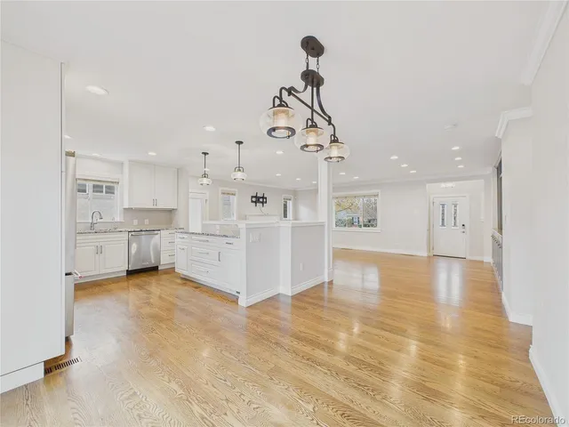 a view of a kitchen with a sink stainless steel appliances and cabinets