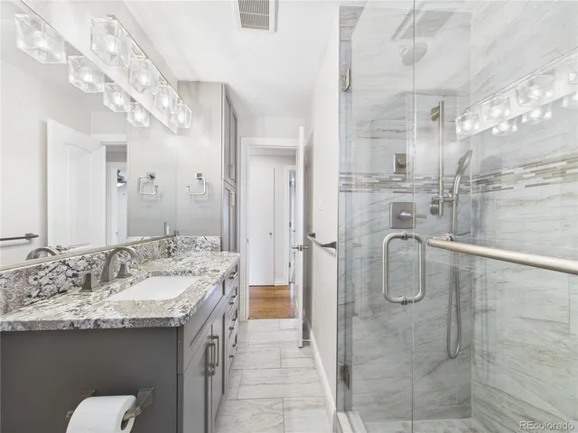 a bathroom with a sink double vanity and shower