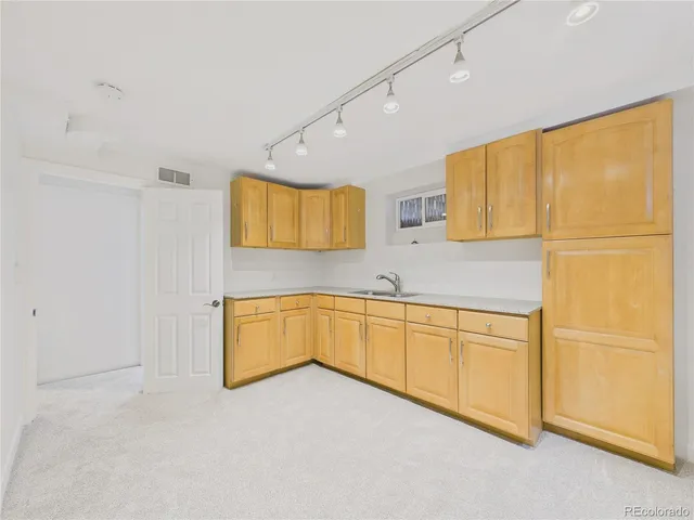 a spacious bathroom with a granite countertop sink and a bathtub