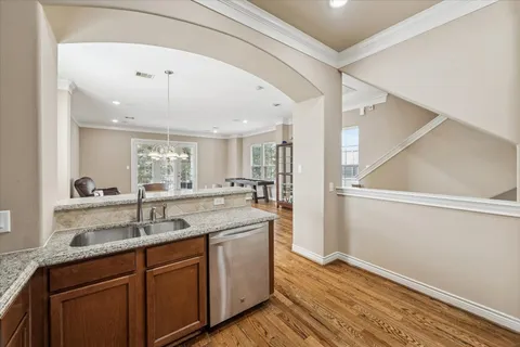 a kitchen with stainless steel appliances granite countertop a refrigerator a stove a sink and a microwave