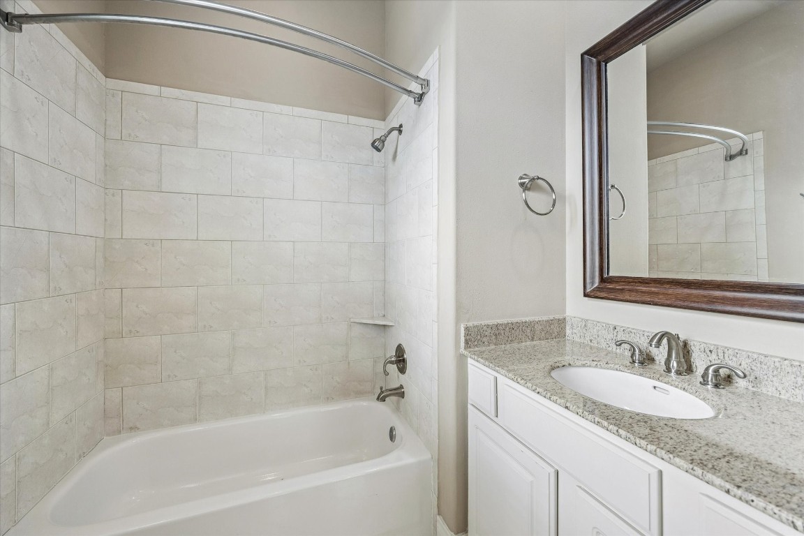 1020 Wagner Street Houston, TX 77007 - Photo 19 of 28 a bathroom with a granite countertop sink and a mirror