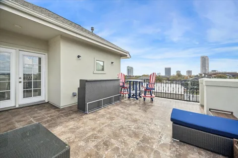 a balcony with a bench and white walls