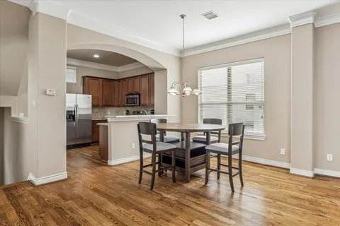 a view of a kitchen with dining table and chairs