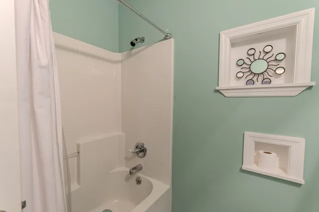 a bathroom with a bathtub and shower