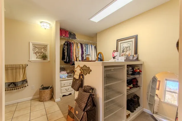 a view of a study room with workspace and a window
