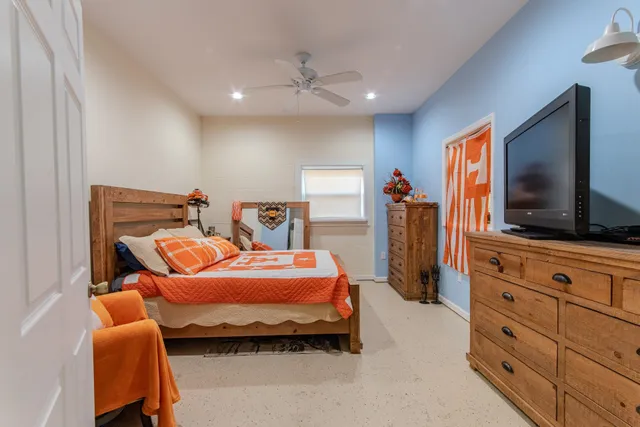 a bedroom with bed and flat screen tv