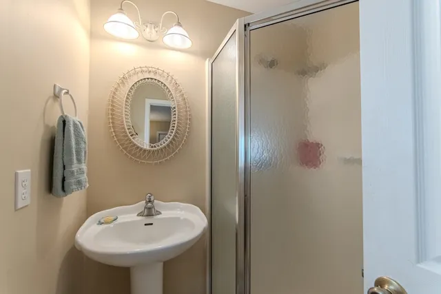 a bathroom with a sink mirror and vanity