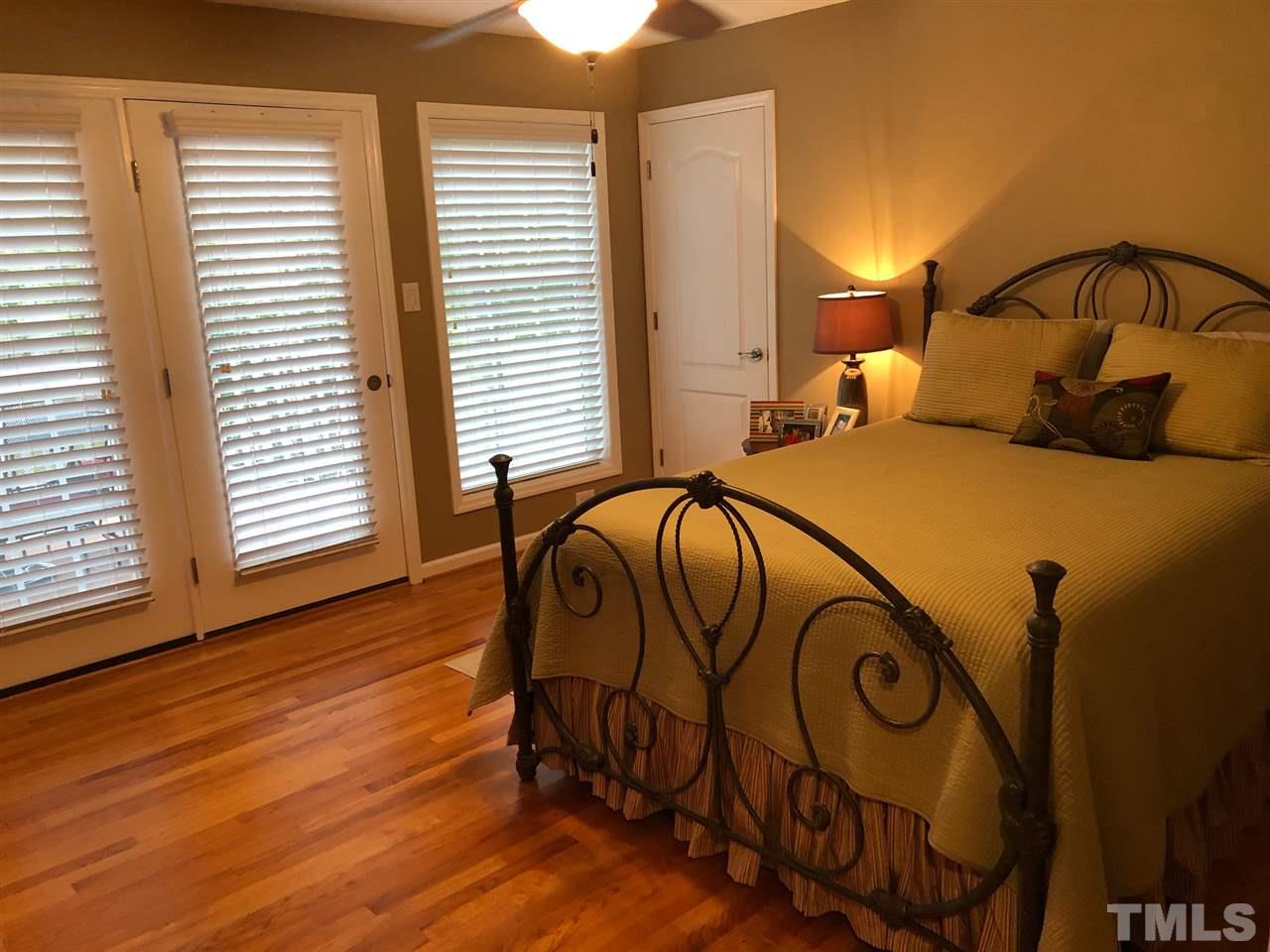 9552 George Ruff Road Bullock, NC 27507 - Photo 14 of 30 a bedroom with a bed and wooden floor