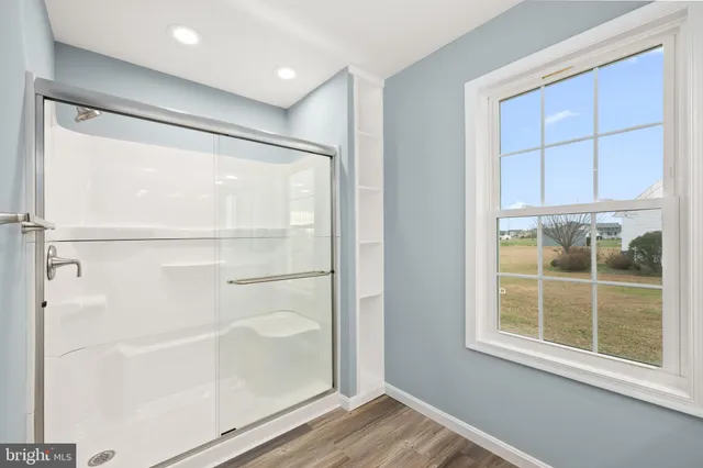 a view of a small space with wooden floor and a window