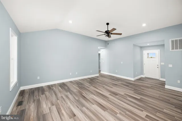 wooden floor in an empty room with a window