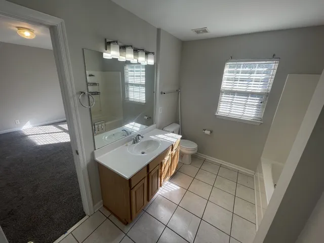 en empty room with windows and ceiling fan