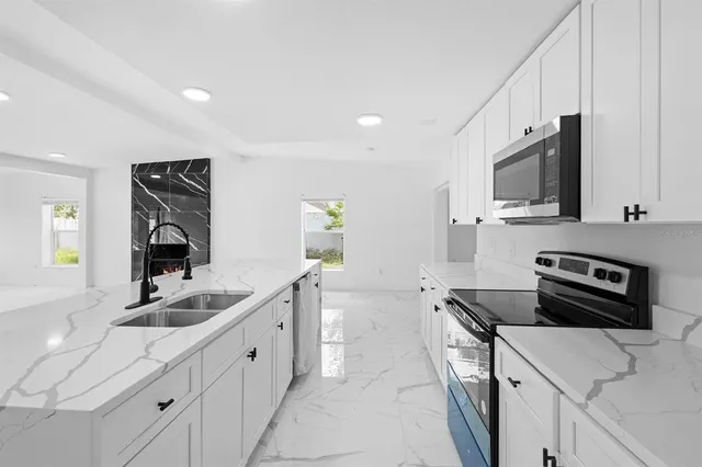 an aerial view of residential houses with outdoor space and river