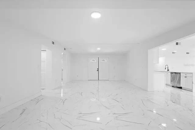 a view of a kitchen with a sink and cabinets in it