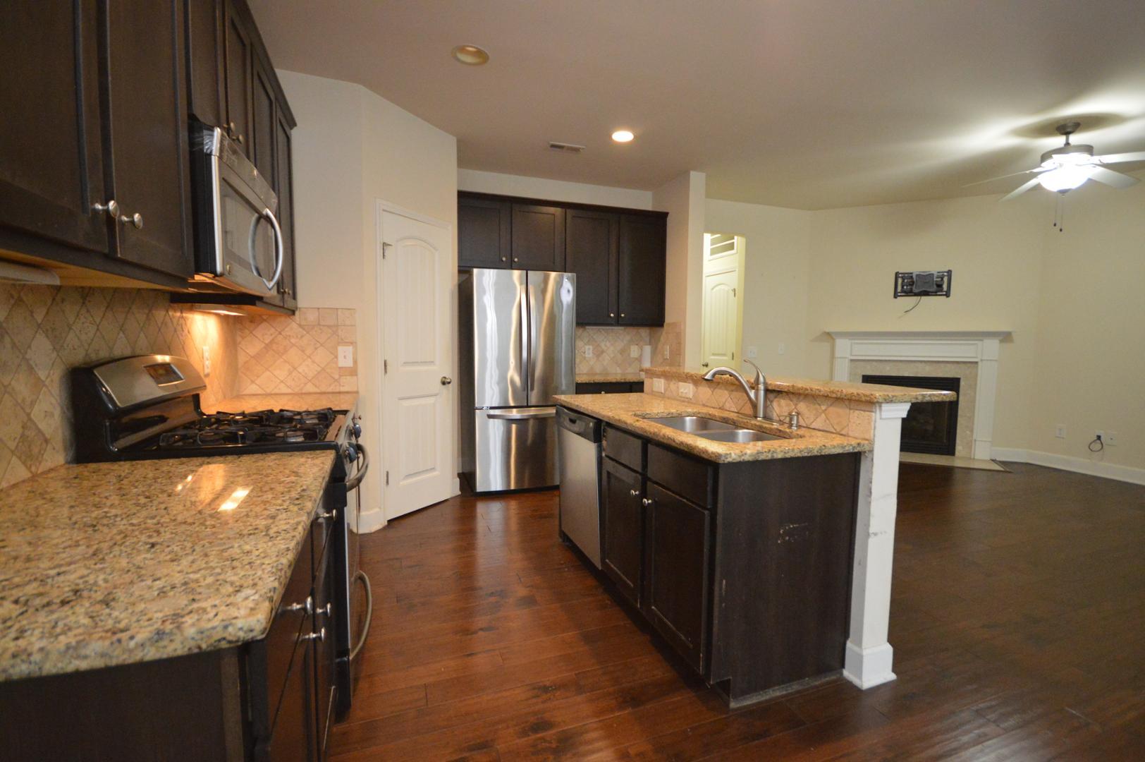 2053 Weston Green Loop Cary, NC 27513 - Photo 11 of 35 a kitchen with stainless steel appliances granite countertop a stove a refrigerator and a sink