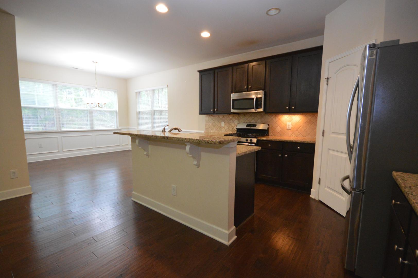 2053 Weston Green Loop Cary, NC 27513 - Photo 12 of 35 a kitchen with stainless steel appliances granite countertop a refrigerator a sink dishwasher a stove and a microwave oven on granite countertops