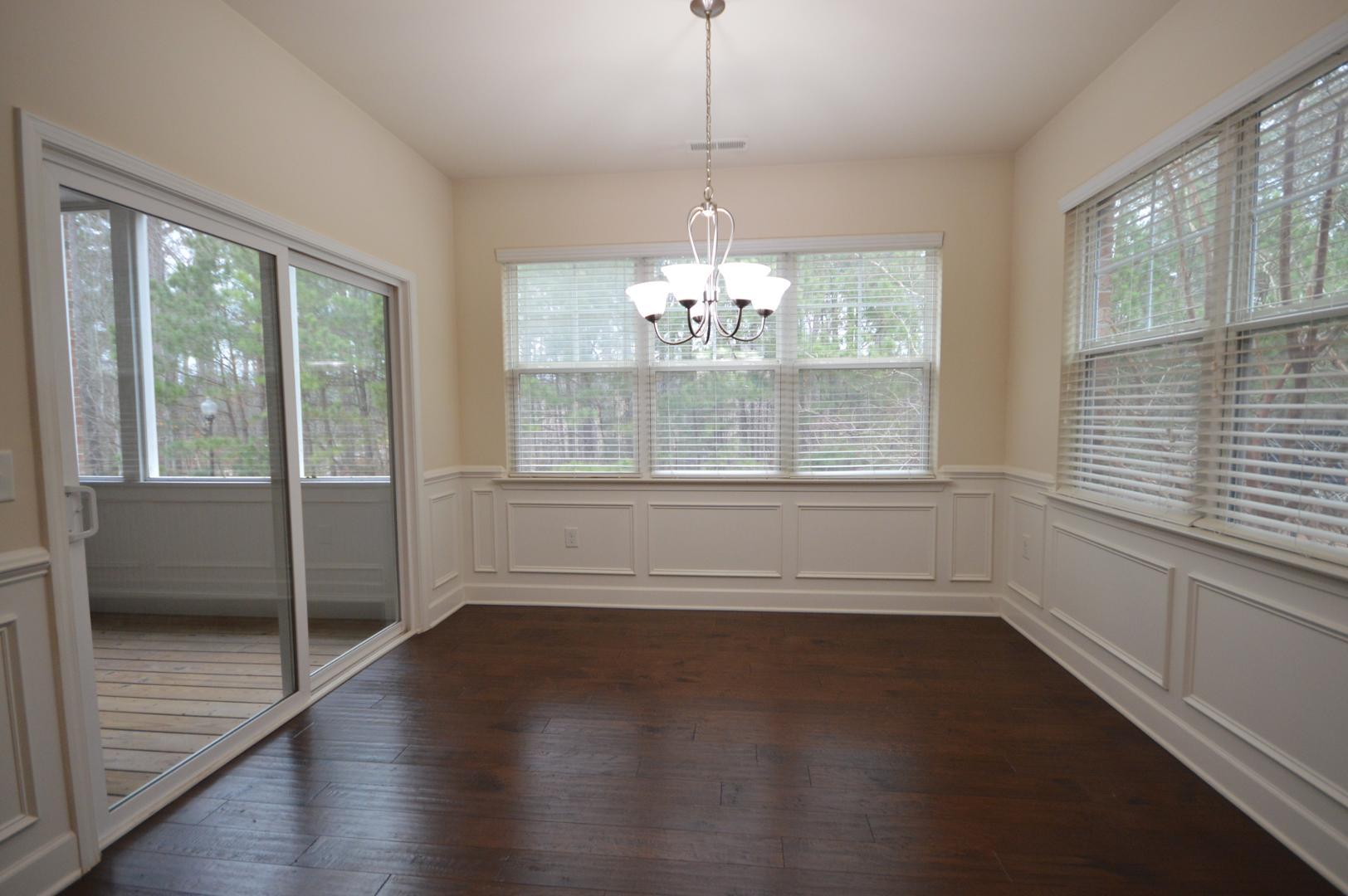 2053 Weston Green Loop Cary, NC 27513 - Photo 14 of 35 a view of an empty room with wooden floor and a window