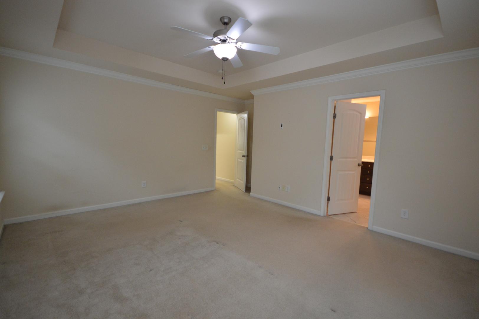 2053 Weston Green Loop Cary, NC 27513 - Photo 19 of 35 an empty room with a chandelier fan and a window