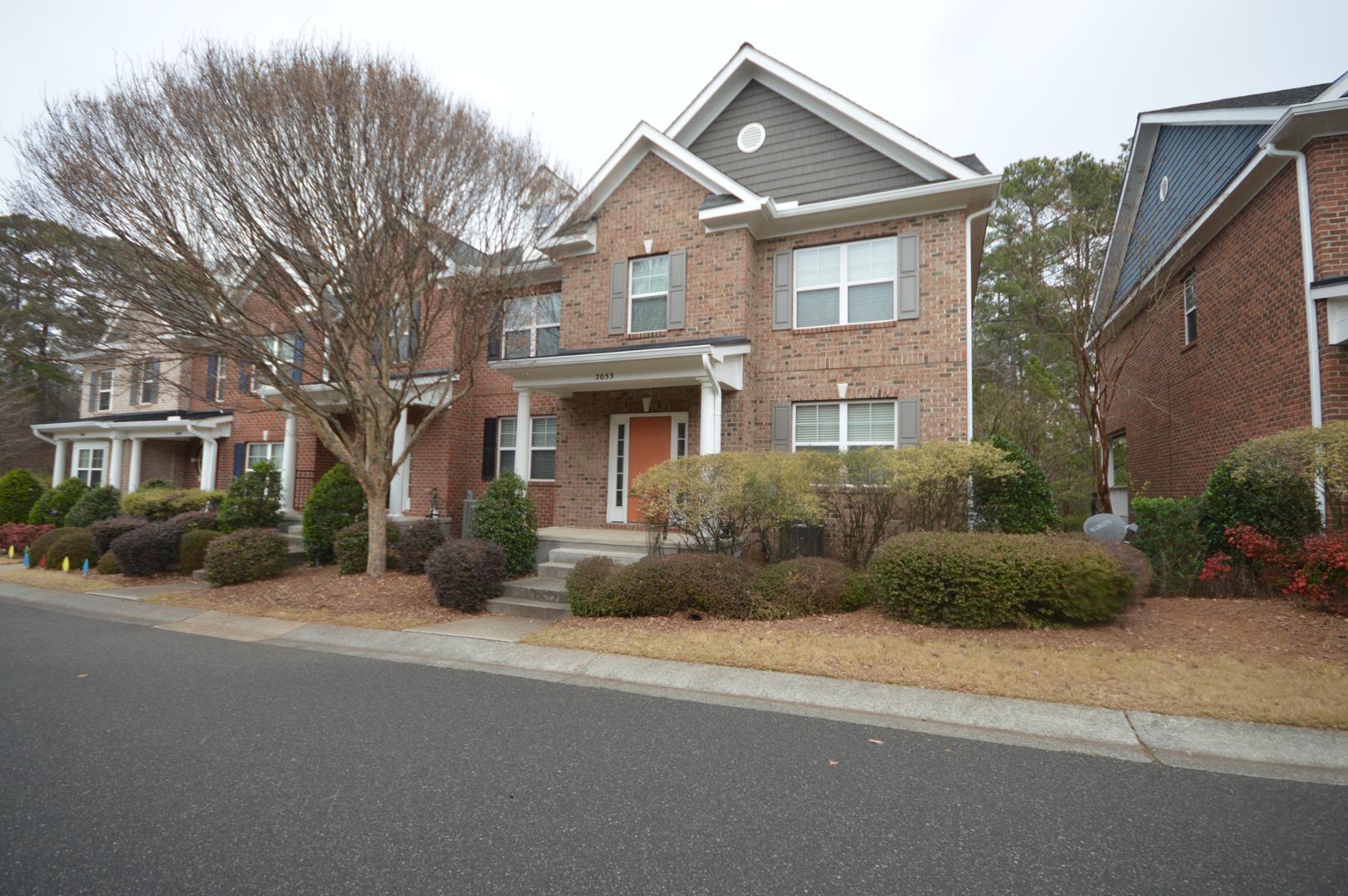 2053 Weston Green Loop Cary, NC 27513 - Photo 2 of 35 a front view of a house with a garden
