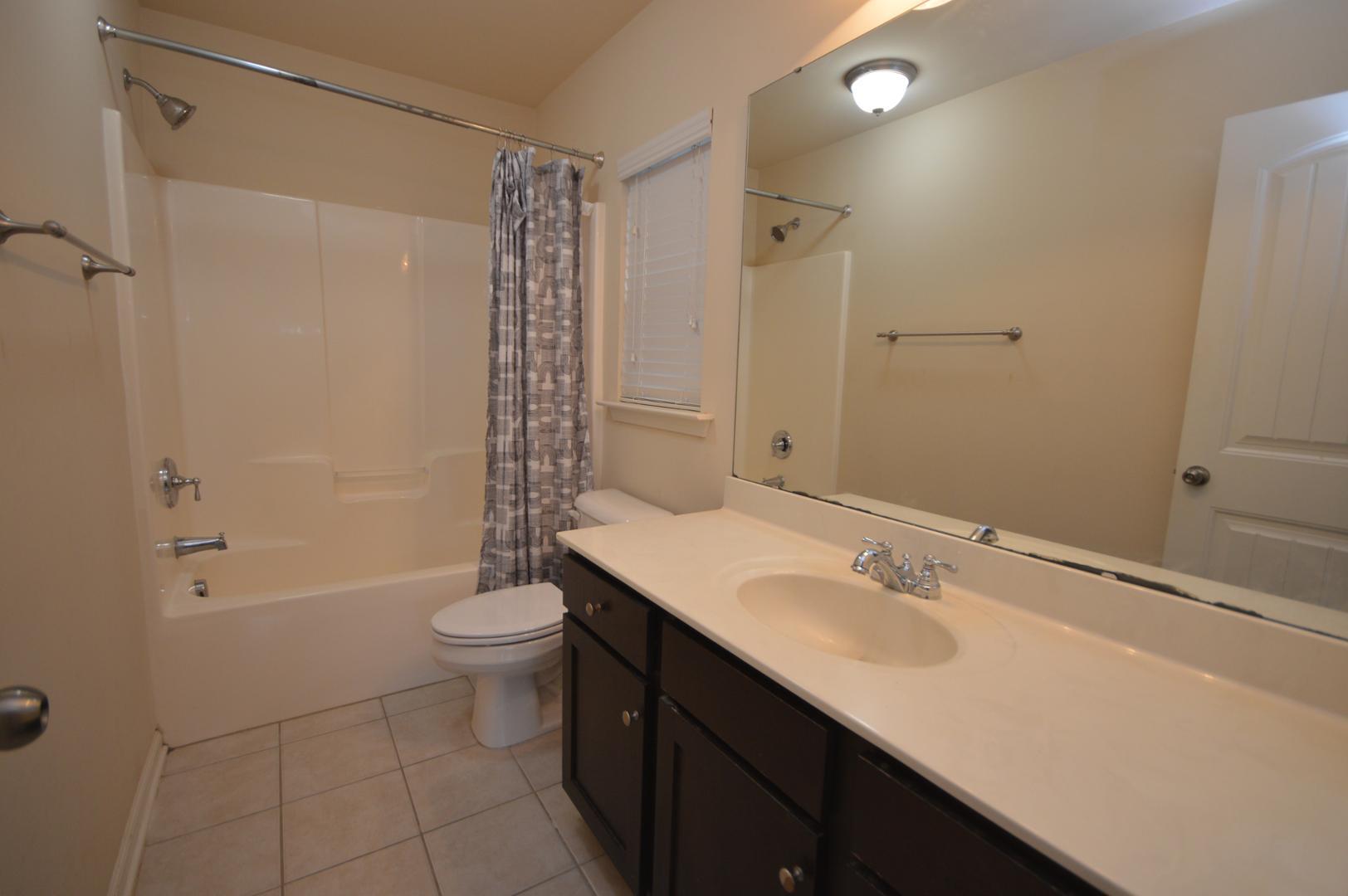 2053 Weston Green Loop Cary, NC 27513 - Photo 26 of 35 a bathroom with a sink a toilet and shower