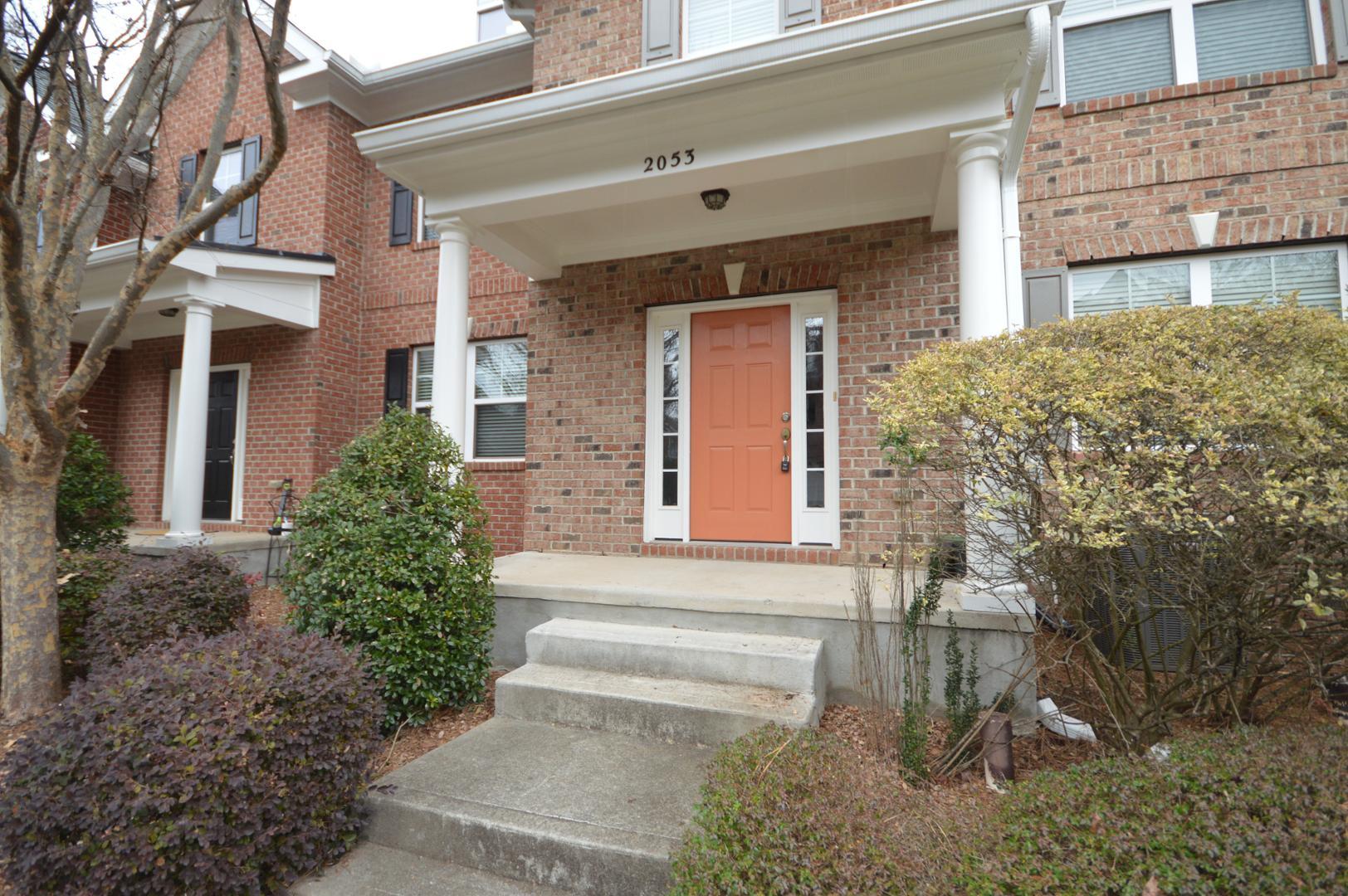 2053 Weston Green Loop Cary, NC 27513 - Photo 4 of 35 a front view of a house with a garden