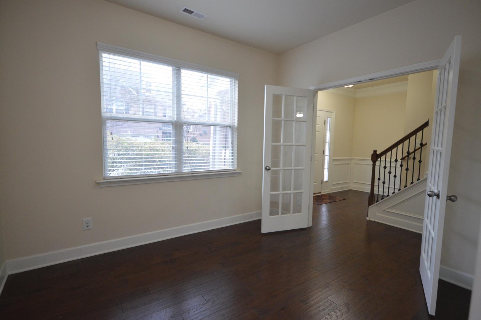 2053 Weston Green Loop Cary, NC 27513 - Photo 7 of 35 an empty room with wooden floor and windows