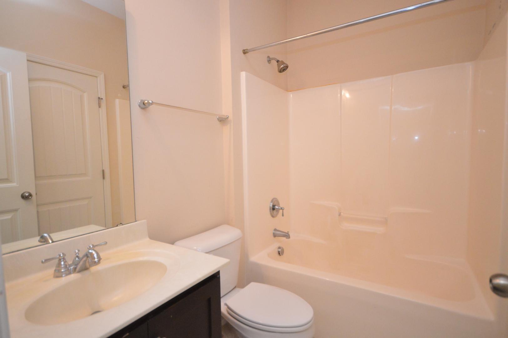 2053 Weston Green Loop Cary, NC 27513 - Photo 8 of 35 a bathroom with a sink a toilet and shower