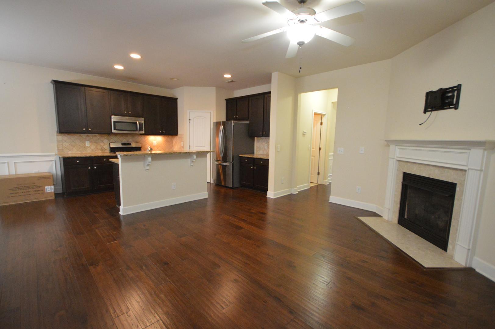 2053 Weston Green Loop Cary, NC 27513 - Photo 9 of 35 a view of a kitchen with a sink stove cabinets and empty room