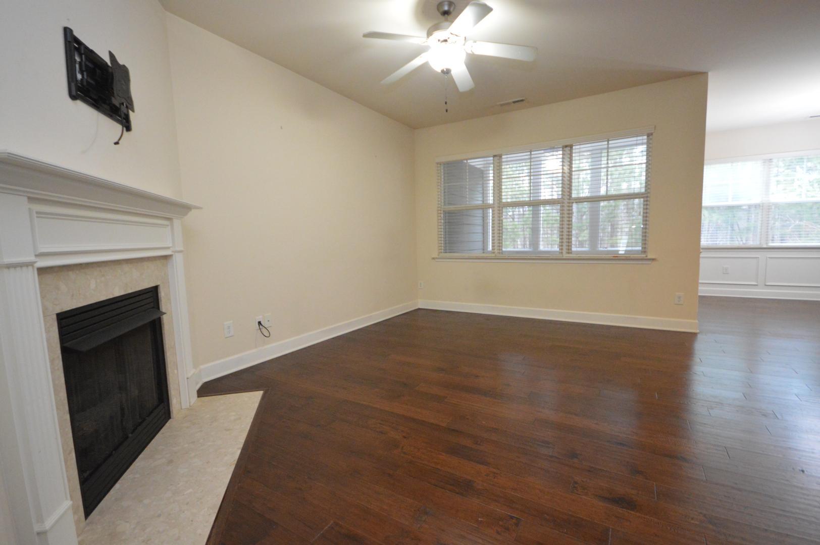 2053 Weston Green Loop Cary, NC 27513 - Photo 10 of 35 a view of an empty room with wooden floor and a window