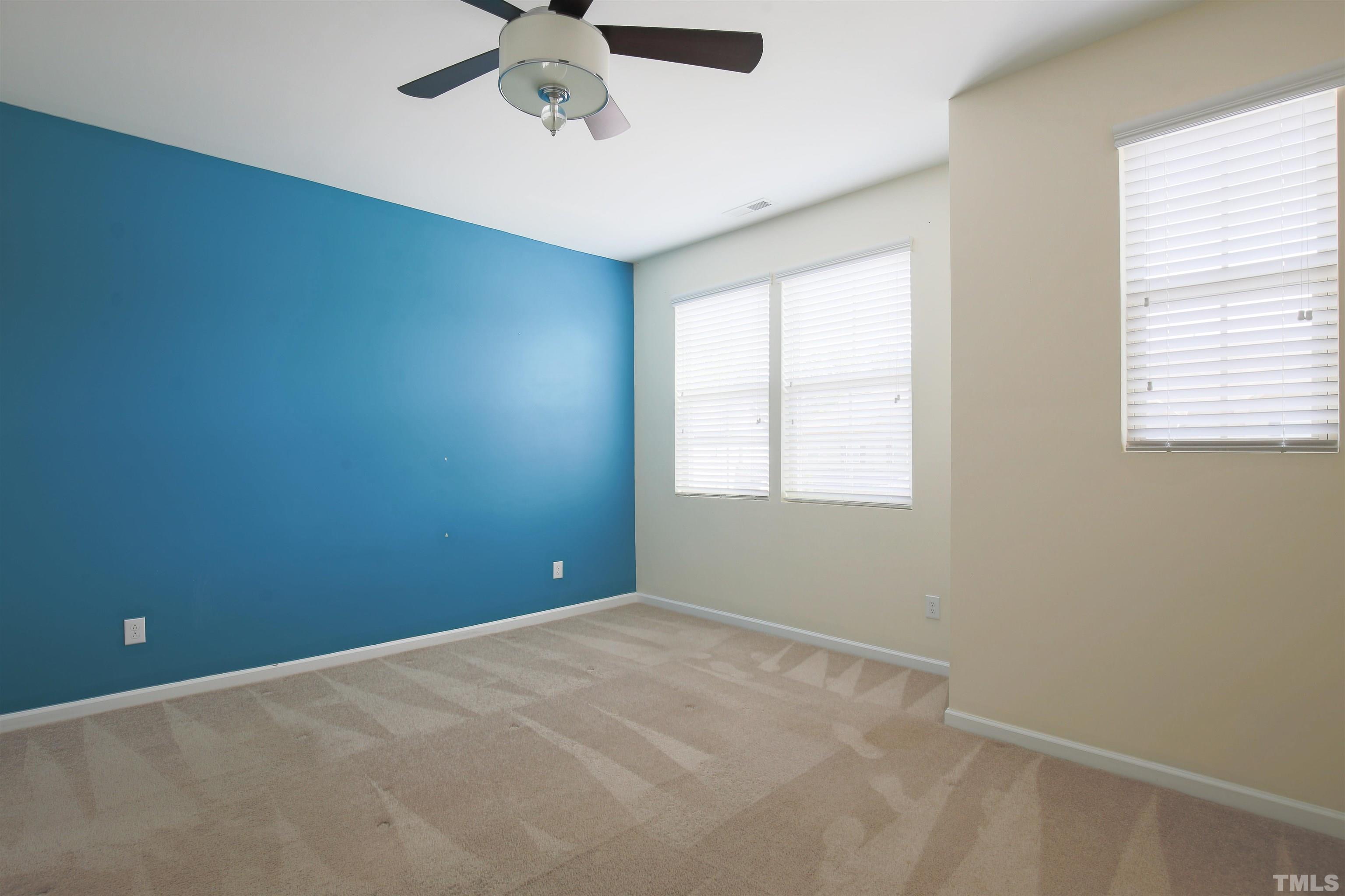 696 Wickham Ridge Road Apex, NC 27539 - Photo 14 of 24 an empty room with a window and a fan