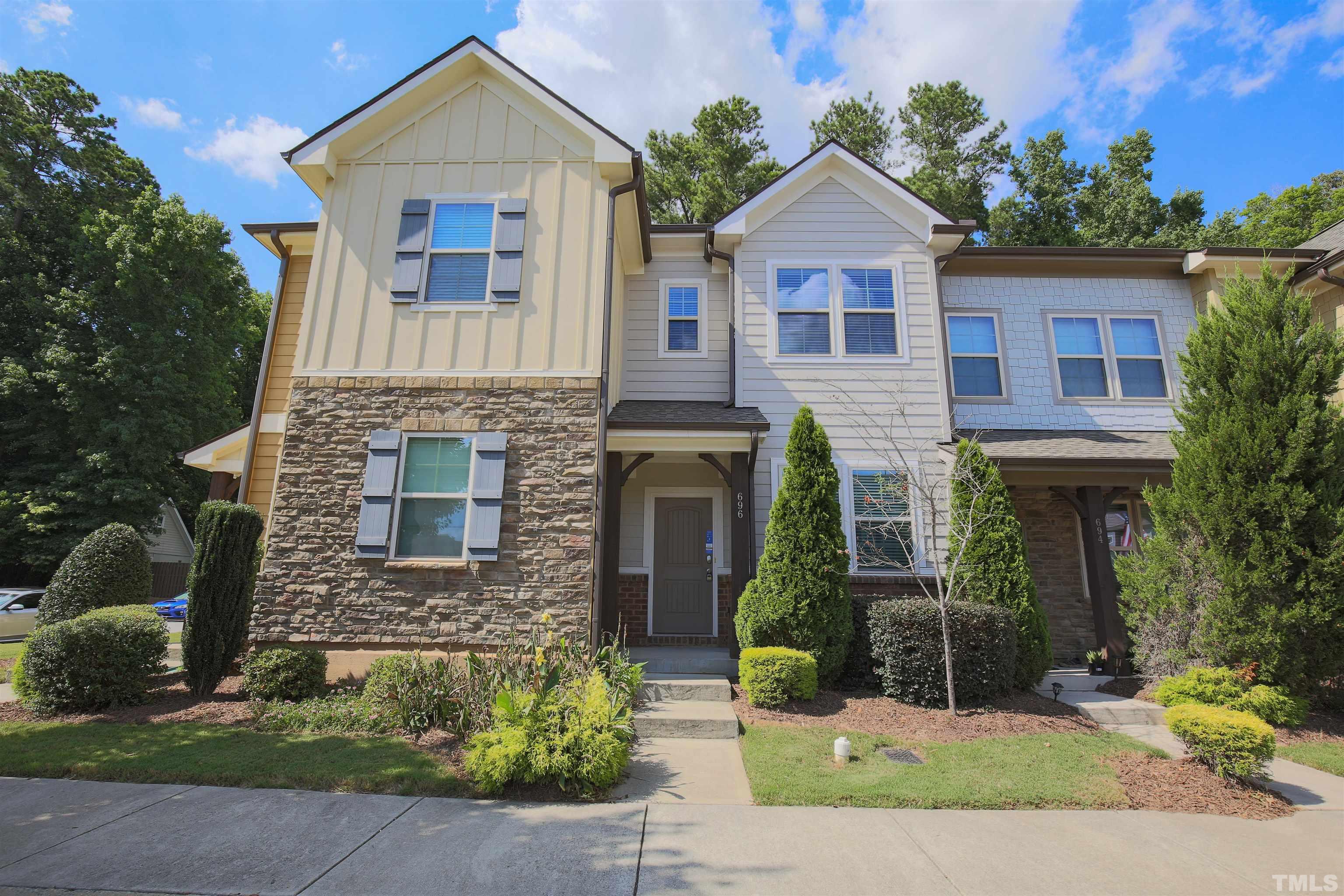 696 Wickham Ridge Road Apex, NC 27539 - Photo 20 of 24 a front view of a house with a yard