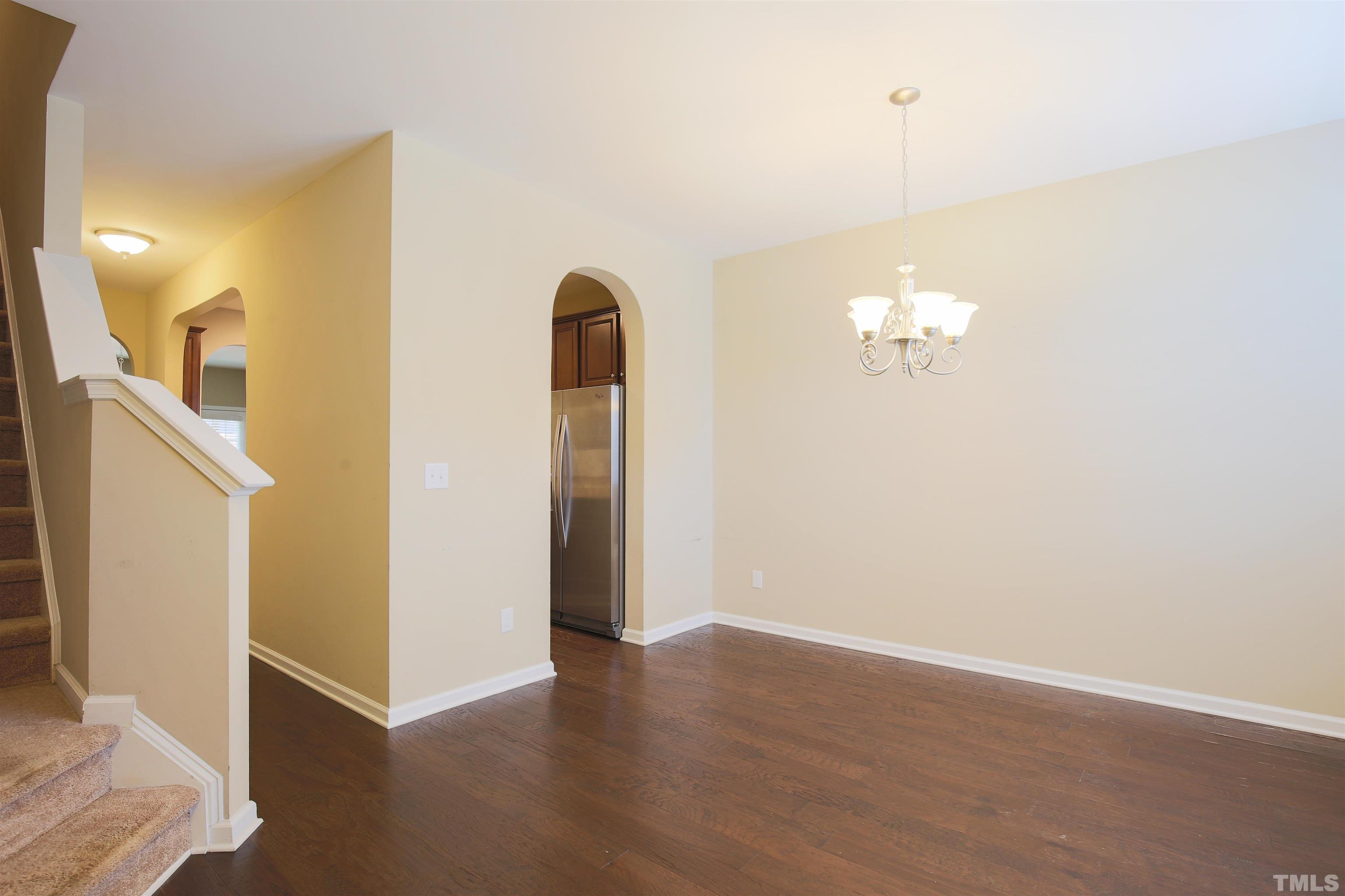 696 Wickham Ridge Road Apex, NC 27539 - Photo 6 of 24 a view of a room with wooden floor and staircase