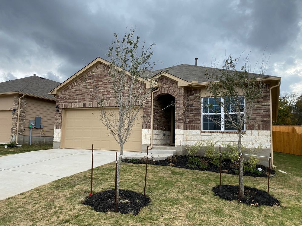 Ranch-style house featuring brick siding, an attached garage, concrete driveway, and roof with shingles