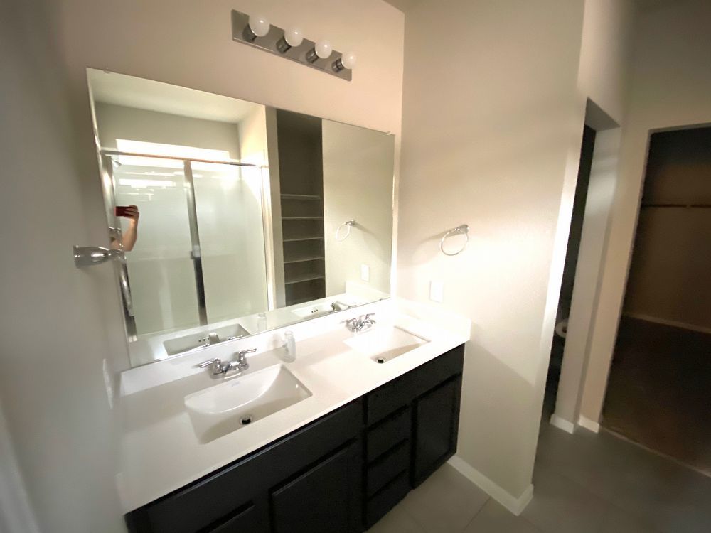 6713 Ranchito Drive Austin, TX 78744 - Photo 11 of 12 Bathroom with a shower stall and double vanity