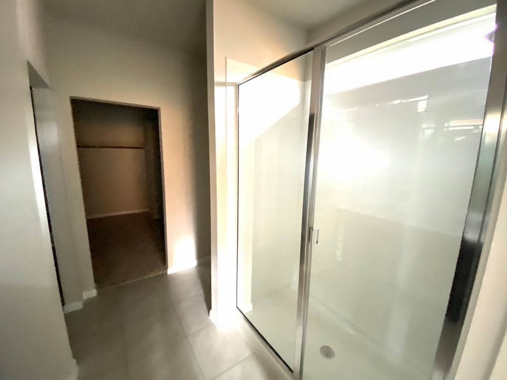 6713 Ranchito Drive Austin, TX 78744 - Photo 12 of 12 Full bath featuring a shower stall and light tile patterned flooring