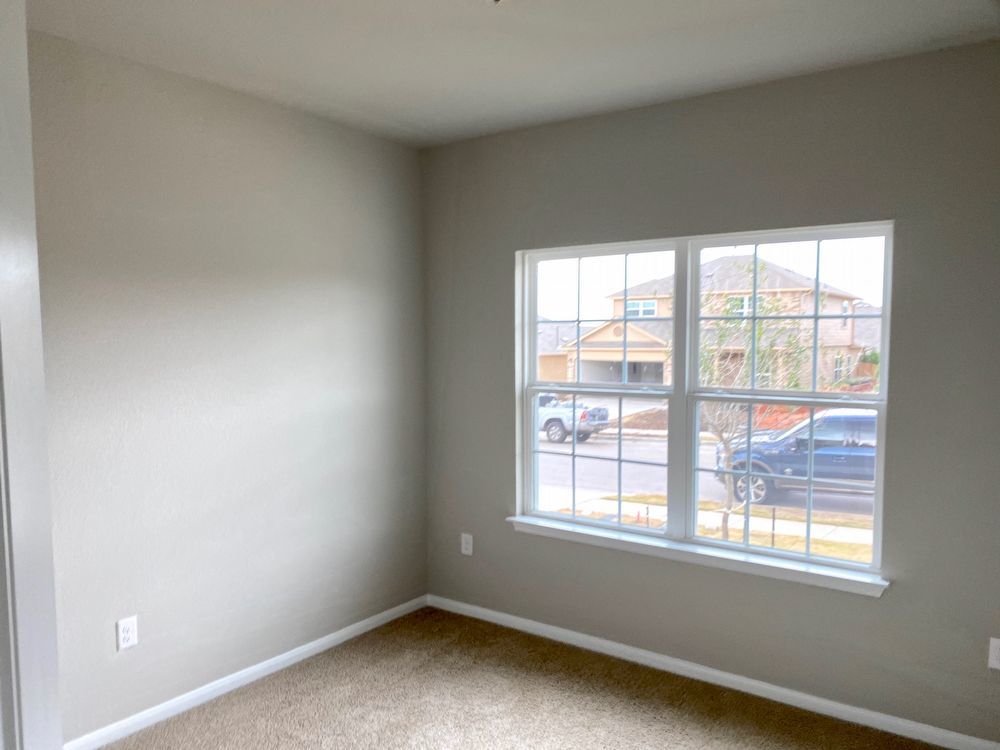 6713 Ranchito Drive Austin, TX 78744 - Photo 3 of 12 Unfurnished room with baseboards and light colored carpet