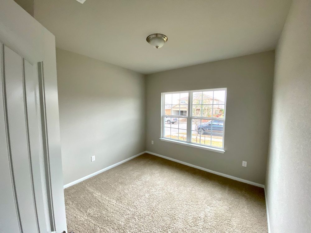 6713 Ranchito Drive Austin, TX 78744 - Photo 4 of 12 Empty room featuring baseboards and light carpet