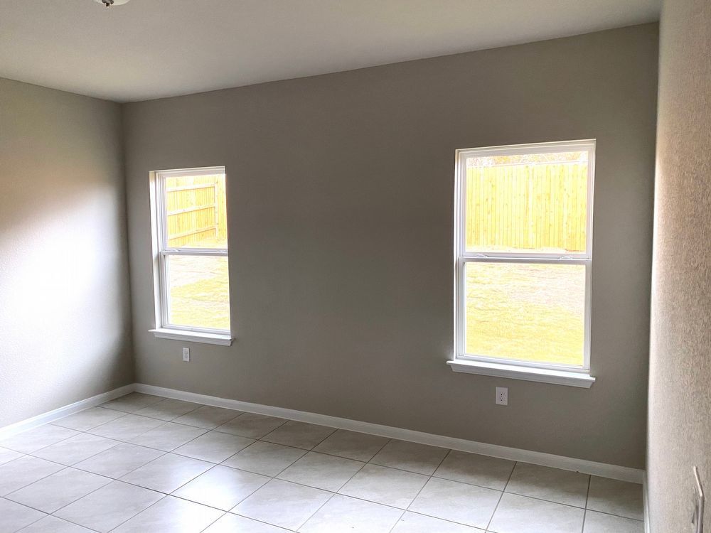 6713 Ranchito Drive Austin, TX 78744 - Photo 9 of 12 Spare room featuring baseboards