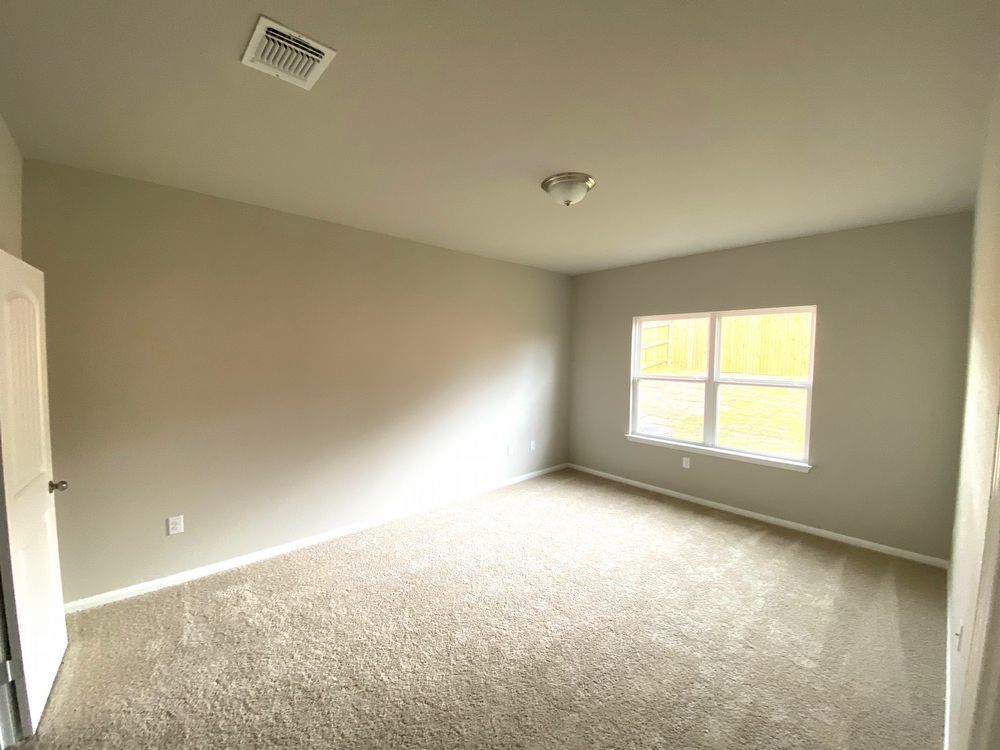 6713 Ranchito Drive Austin, TX 78744 - Photo 10 of 12 Empty room featuring light carpet and baseboards