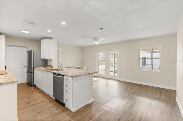 a kitchen with stove and wooden floor