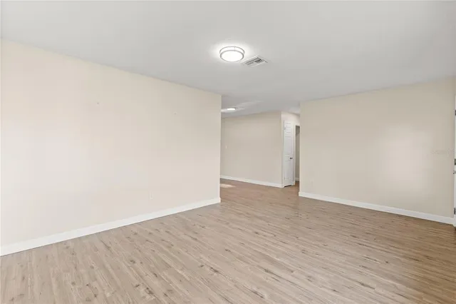 a view of an empty room and wooden floor