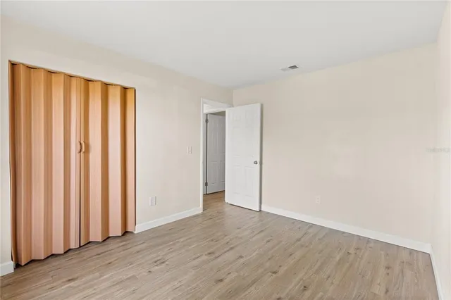 a view of a room with wooden floor