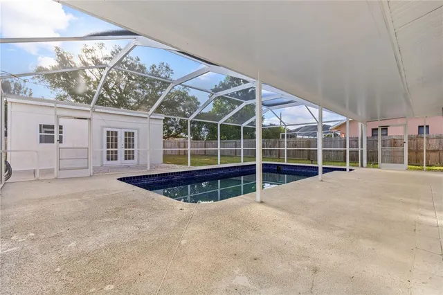 a view of a house with a backyard and balcony